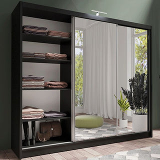 Black sliding wardrobe with full mirrored doors showing interior shelves.