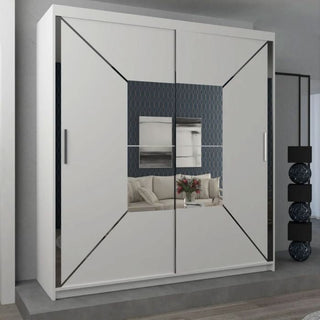 The BARTHOLOMEW 2 Door Mirrored Sliding Wardrobe in white (120cm) stands on a raised platform. Its high-gloss mirrored doors reflect a living room with a beige sofa, glass coffee table with flowers, and patterned wallpaper.