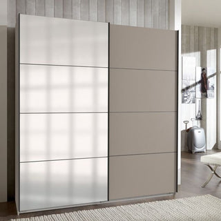 The ANVAST 2 Door Mirrored Wardrobe Grey 225cm features a modern sliding design with a mirrored door and a matte grey door, providing stylish bedroom storage in rooms with neutral decor and textured walls.