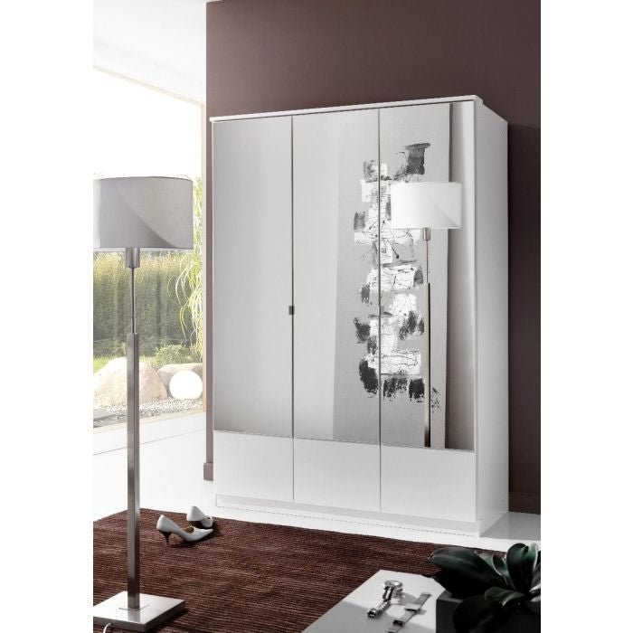 The CHOICEWARDROBE Inagu 135cm 3 Door Mirrored Wardrobe in a white finish with pull out drawers stands against a brown wall, reflecting a modern floor lamp. Greenery is visible through the window, and shoes rest on the brown rug nearby.