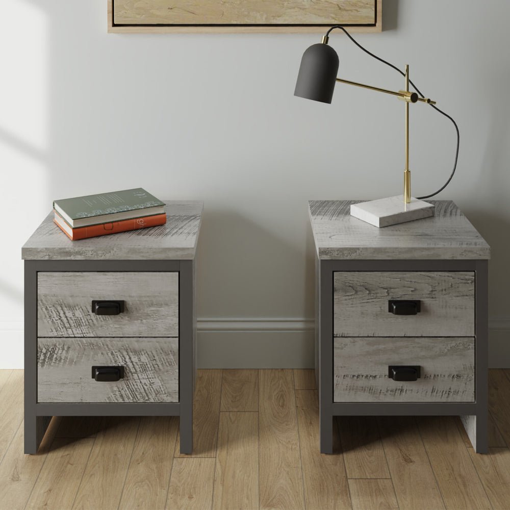 Balcombe grey wood bedside cabinets, pair, each with two drawers. One shown with books, other with desk lamp.