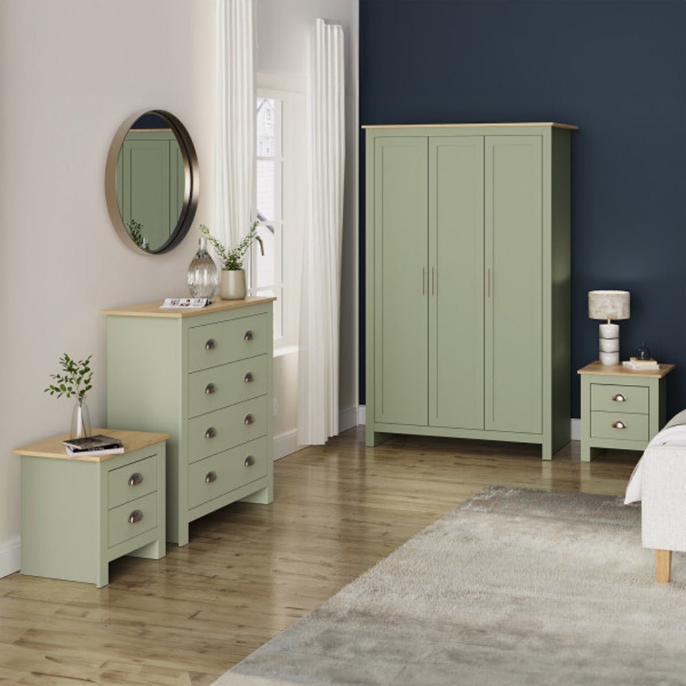 Sage green 3-door wardrobe, chest of drawers, and two bedside cabinets from the Loftus range with oak tops. Round mirror above chest.