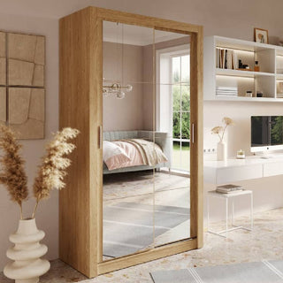 Natural oak sliding wardrobe with full mirror doors featured in a bright UK bedroom, combining warm wood tones and space-saving modern design.