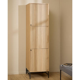The CHOICEWARDROBE Attica Hinged Wardrobe, featuring 2 doors with oak and matt black lamella fronts, stands against a beige wall on a light wood floor. A gray bench with magazines is partially visible on the right.