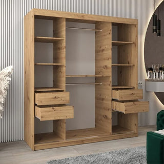 The Beloit Mirrored Wardrobe with 2 sliding doors in artisan oak features multiple shelves, four partially open drawers, and two hanging rods, standing against a modern room with striped wall paneling and a round mirror.