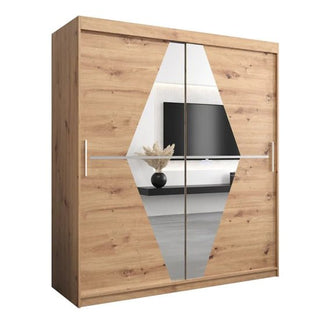 The Beloit Mirrored Wardrobe features two sliding doors with diamond-shaped mirrors at the center, crafted in light brown artisan oak with a natural finish—the mirrors reflect a TV, shelf, and vase with dried plants.