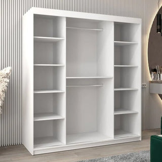 The Beloit Mirrored Wardrobe with 2 sliding doors (180cm, White) stands against a striped wall in a modern room, offering versatile bedroom storage with multiple compartments and hanging space.