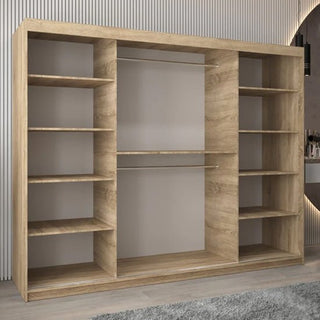 The Beloit Mirrored Wardrobe 3 Sliding Doors 250cm in Sonoma Oak stands on a gray carpet in a modern room with light-colored walls, featuring storage shelves and hanging space for organized clothing.