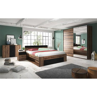 Modern bedroom with a wooden bed, green walls, large window, Biloxi Mirrored Wardrobe 2 Sliding Doors 180cm in Monastery Oak, nightstand, chest of drawers, two pendant lights, gray rug, and two floor cushions on light wood flooring.