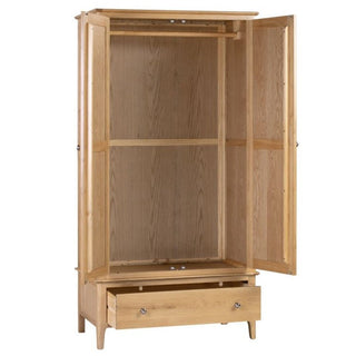 The Callia Wooden Wardrobe With 2 Doors 1 Drawer In Natural features a solid oak build, open doors revealing an empty space with a hanging rail, a spacious lower drawer, and sleek metal handles—a stylish light wood bedroom storage solution.