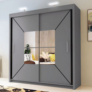 The CHOICEWARDROBE 120cm Sliding Door Mirrored Wardrobe in matt grey features a geometric panel design and central mirror, adding sleek style to rooms with small tables, flowers, and decorative plants.