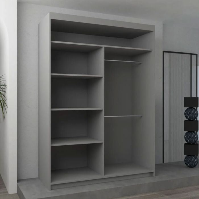 The CHOICEWARDROBE Bartholomew 120cm Sliding Door Wardrobe in matt grey, featuring a central mirror and geometric panel design, stands against a light-colored wall in a modern minimalistic room.