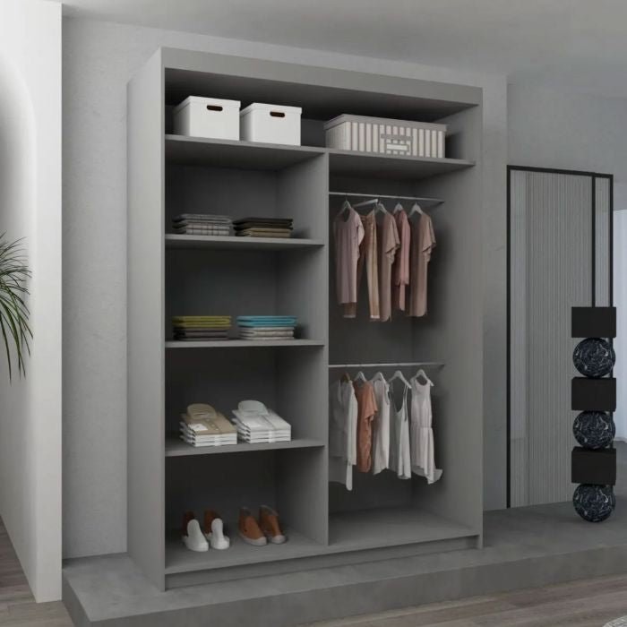 The CHOICEWARDROBE Bartholomew 120cm Sliding Door Wardrobe in matt grey features a central mirror, geometric panel design, shelves for clothes and storage boxes, two hanging rails, and blends elegantly against a neutral-colored wall.