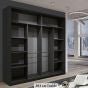 The CHOICEWARDROBE 180cm Black Sliding Door Wardrobe with wave mirrored glass front, shelving, and hanging space stands in a modern minimalistic room with light flooring and large windows.