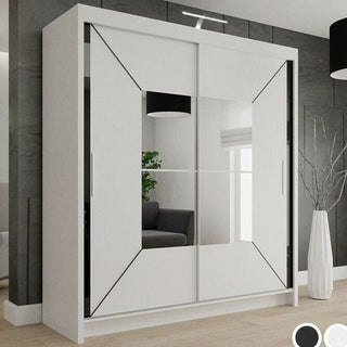 The CHOICEWARDROBE 203cm Sliding Door Mirrored Wardrobe in matt white with a geometric diagonal panel design stands against a grey wall on wooden flooring, its mirrors reflecting a sofa, window, and ceiling light.