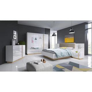 A modern bedroom with dark gray walls, a white glossy bed, a CHOICEWARDROBE Alaro High Gloss White Mirrored 4 Door Wardrobe with gold trim, dresser, nightstand, light wood accents, pendant lights, and a geometric rug on a white floor.