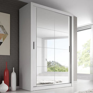 The CHOICEWARDROBE Aliso 120cm White Mirrored Sliding Door Wardrobe, featuring a full-length mirror and dual hanging rails, adds elegance and practical storage to a modern room with gray walls, vases, and geometric artwork.
