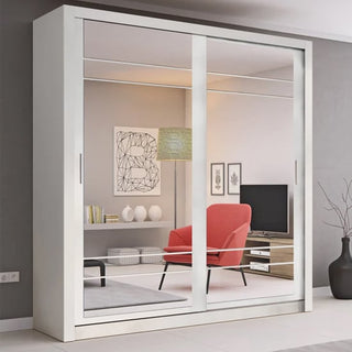 The CHOICEWARDROBE Allen 2 Door Mirrored Sliding Wardrobe (203cm, matt white) reflects a modern living room with a red armchair, TV on a wooden stand, wall art, and a hanging lamp.