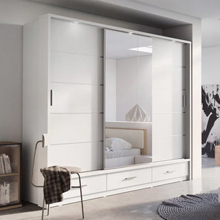 The CHOICEWARDROBE Allen 250cm White Sliding Door Wardrobe with Mirror features 3 doors, drawers, and a LED-ready modern design. A chair with a plaid blanket sits beside it, with bookshelves and a bed also visible in the room.