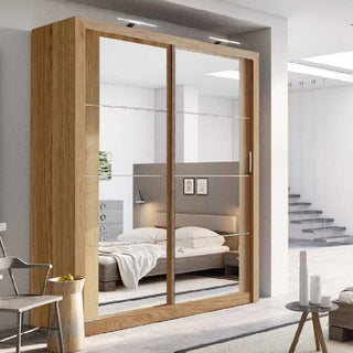 A bedroom with a CHOICEWARDROBE Allen Oak 2 Door Sliding Mirrored Wardrobe (181cm, LED lights, storage shelves) reflects a bed, nightstand, and decor. The modern gray and white room has a staircase visible in the background.