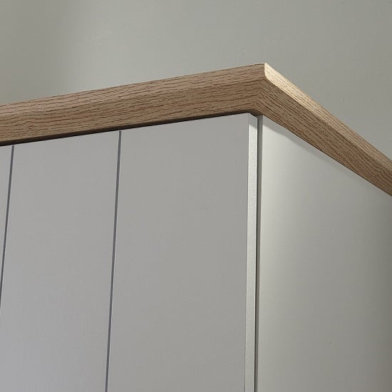Close-up of CHOICEWARDROBE Alverton 3 door wardrobe in grey with oak effect top and wood trim.