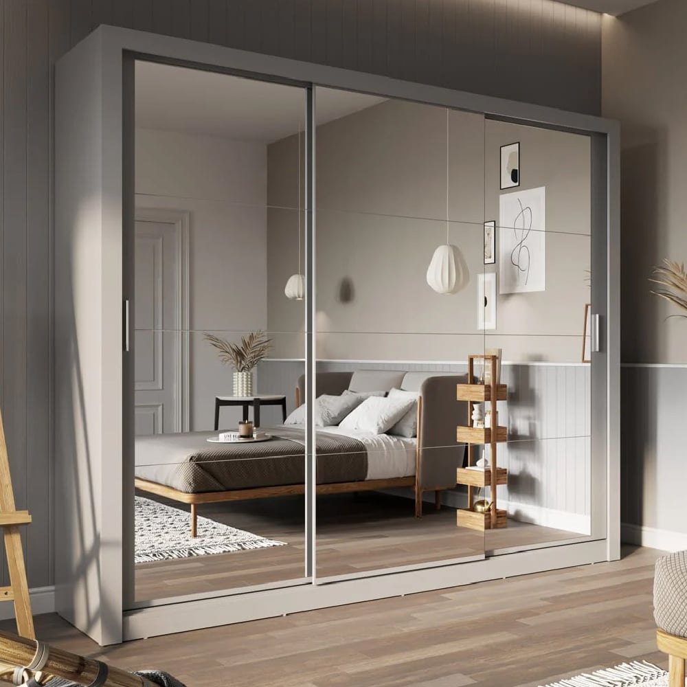 Grey 3-door sliding wardrobe with full-length mirrored doors in a modern bedroom