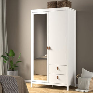 The CHOICEWARDROBE Barcila 102cm Mirrored 2 Door Wooden Wardrobe in white with 2 storage drawers and a hanging rail stands against a beige wall, topped with woven baskets and placed near a green plant and a partially visible bed.