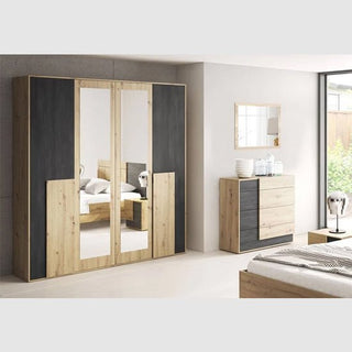 A modern bedroom with the CHOICEWARDROBE Barrie 4 Door Mirrored Wardrobe in 200cm oak & anthracite finish, featuring full-length mirrors, shelving, and hanging storage, complemented by a matching dresser and neutral decor.