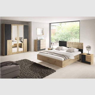 A modern bedroom featuring a wooden bed, two matching nightstands, a chest of drawers, a CHOICEWARDROBE Barrie 4 Door Mirrored Wardrobe in 200cm oak & anthracite finish with shelving and hanging storage, a gray rug, and a large window overlooking greenery.