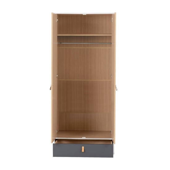 Open oak effect wardrobe interior with shelf, hanging rail, and grey drawer with light handle.