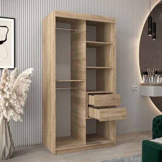 Sonoma Oak wardrobe with sliding doors showing shelves and open drawers.
