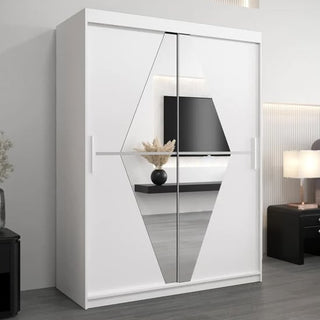 The CHOICEWARDROBE Beloit 2 Door Sliding Mirrored Wardrobe (150cm, Matt White) with geometric mirror design complements a modern bedroom with gray floors, black side table, wall TV, and lamp. Stylish and functional storage solution.