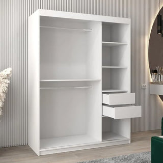 The CHOICEWARDROBE Beloit 2 Door Sliding Mirrored Wardrobe (150cm, Matt White) with a geometric mirror design stands on a light wood floor against a wall with vertical lines; mirrored elements and vanity are visible to the right.