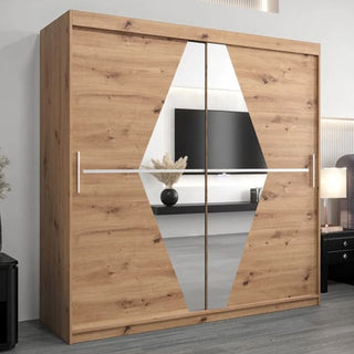 The CHOICEWARDROBE Beloit 200cm Mirrored Sliding Door Wardrobe in artisan oak with a modern geometric mirror design stands in a stylish room featuring a TV, lamp, and decorative vase.