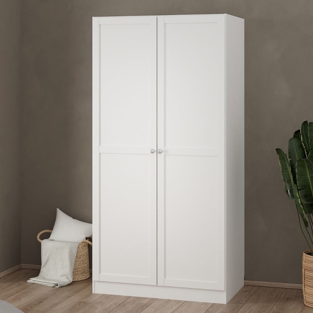 CHOICEWARDROBE Bensalem 2 door white wardrobe with hanging rail against taupe wall.