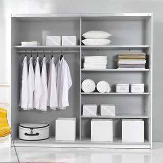 A black CHOICEWARDROBE Biella 200cm 2 Door Sliding Mirrored Wardrobe with shelves and hanging rails, neatly organized with shirts, towels, boxes, pillows, and a white suitcase for a minimalist look.