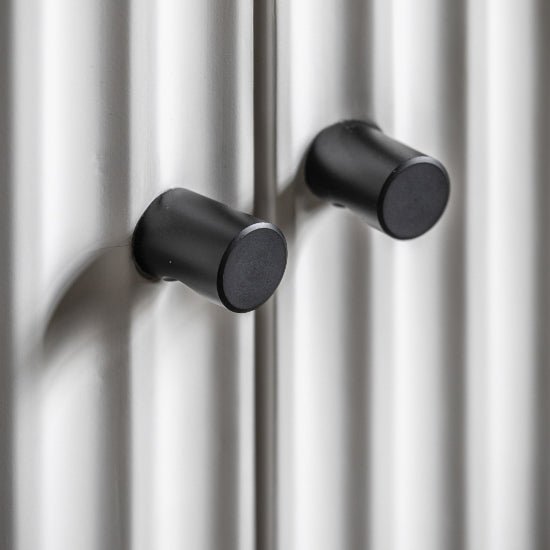 Two black cylindrical handles on white fluted wardrobe doors, CHOICEWARDROBE Bienne