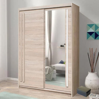 A CHOICEWARDROBE Brentwood 175cm Sliding Wardrobe in Sonoma Oak with 2 doors and a mirror stands in a modern room featuring a bed, blue rug, geometric wall art, and decorative sticks in a vase.