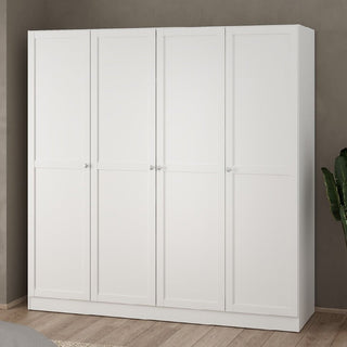 The CHOICEWARDROBE Burbank 4 Door Panelled Wooden Wardrobe in a white shaker style stands against a gray wall on a wooden floor, with a leafy green plant partially visible to the right.