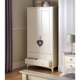The CHOICEWARDROBE Caelia Combi Wardrobe, a 94cm-wide unit in classic white with 2 doors and 3 drawers, stands in the bedroom. One drawer is open, and a purple heart decorates the handles. A matching nightstand and bed are partially visible nearby.