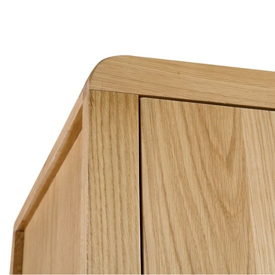 Close-up of CHOICEWARDROBE Camber wooden wardrobe top corner with waxed oak finish and curved edging.