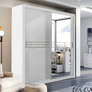 The CHOICEWARDROBE Capri White Sliding 2 Door Wardrobe (203cm, matt finish, mirror & storage shelves) enhances a minimalist space with its sleek design, paired with a lamp, beige ottoman, and snowy mountain views through the window.
