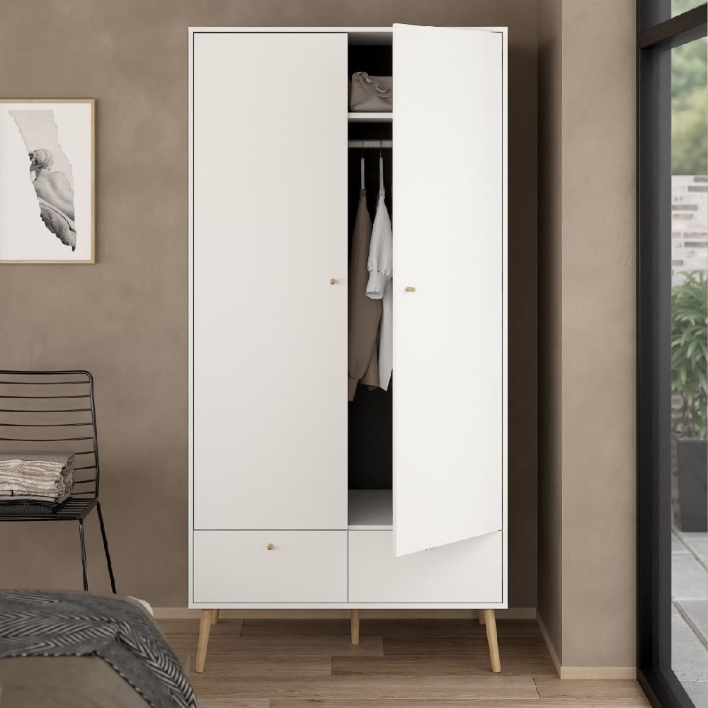 White wooden wardrobe with 2 doors, 2 drawers, and oak legs in modern Scandinavian style.