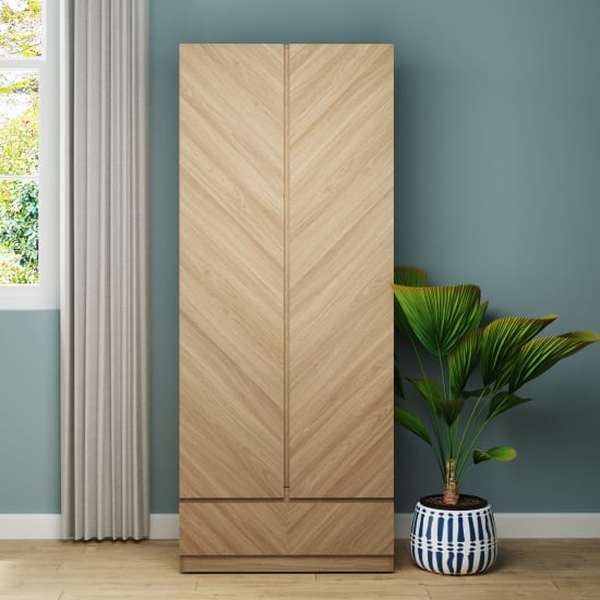 CHOICEWARDROBE Cianna Euro Oak 2 Door Wardrobe with Drawer, Chevron pattern, blue wall.