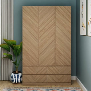 A CHOICEWARDROBE Cianna Royal Walnut 2 Door Wardrobe with Drawer, featuring a chevron pattern luxury finish, stands against a teal wall next to a potted plant, curtains, and partially visible framed artwork.