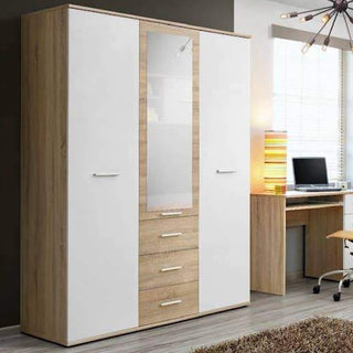 The CHOICEWARDROBE Dania 3 Door Mirrored Wardrobe in white & oak effect (135cm) with drawers stands beside a modern desk setup, creating stylish and practical storage for any contemporary bedroom.