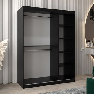 The CHOICEWARDROBE Danville 150cm Black Glass Mirrored Sliding Door Wardrobe, featuring luxury panels, hanging rails, and shelving, stands out against light striped walls and a gray floor.