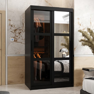 The CHOICEWARDROBE Danville 2 Door Mirrored Sliding Wardrobe in a 100cm black finish adds compact, modern storage with hanging rail and shelves to your bedroom, its sleek reflective design blending style and function against beige marble-patterned walls.