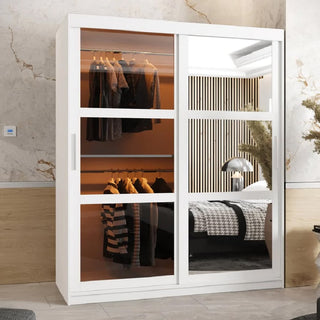 The CHOICEWARDROBE Danville Large Mirrored Wardrobe (150cm, 2 sliding doors, white) features full mirror panels that reflect a stylish bedroom. Inside, adjustable shelving and rails keep garments organized and easily accessible.