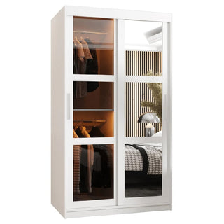 The CHOICEWARDROBE Danville White Mirrored Sliding Door Wardrobe features a modern compact design, smooth-glide doors, interior hanging rail and shelves. The mirrored front reflects a stylish bedroom with a bed and lamp.